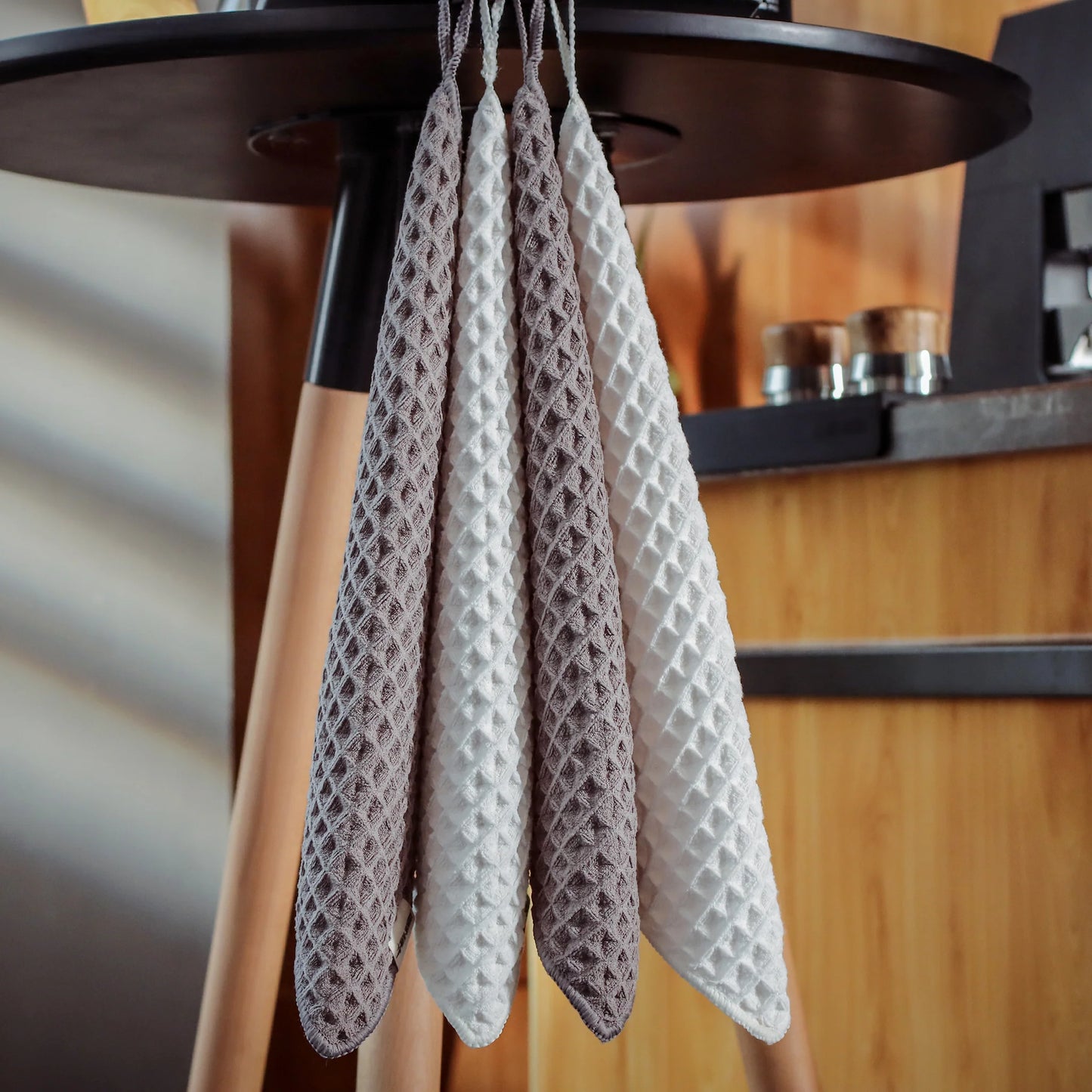 MHW-3BOMBER waffle bar towels hanging. White and grey, honeycomb weave, absorbent. Kitchen setting.