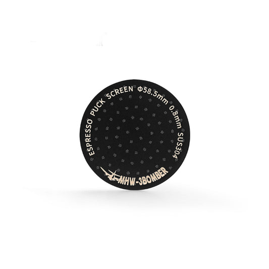 The MHW-3BOMBER Espresso Puck Screen features sleek, black titanium plating with ESPRESSO PUCK SCREEN text along the edge, specifications Φ58.5mm and 0.8mm SUS304, and the bold logo MHW-3BOMBER against a white background.