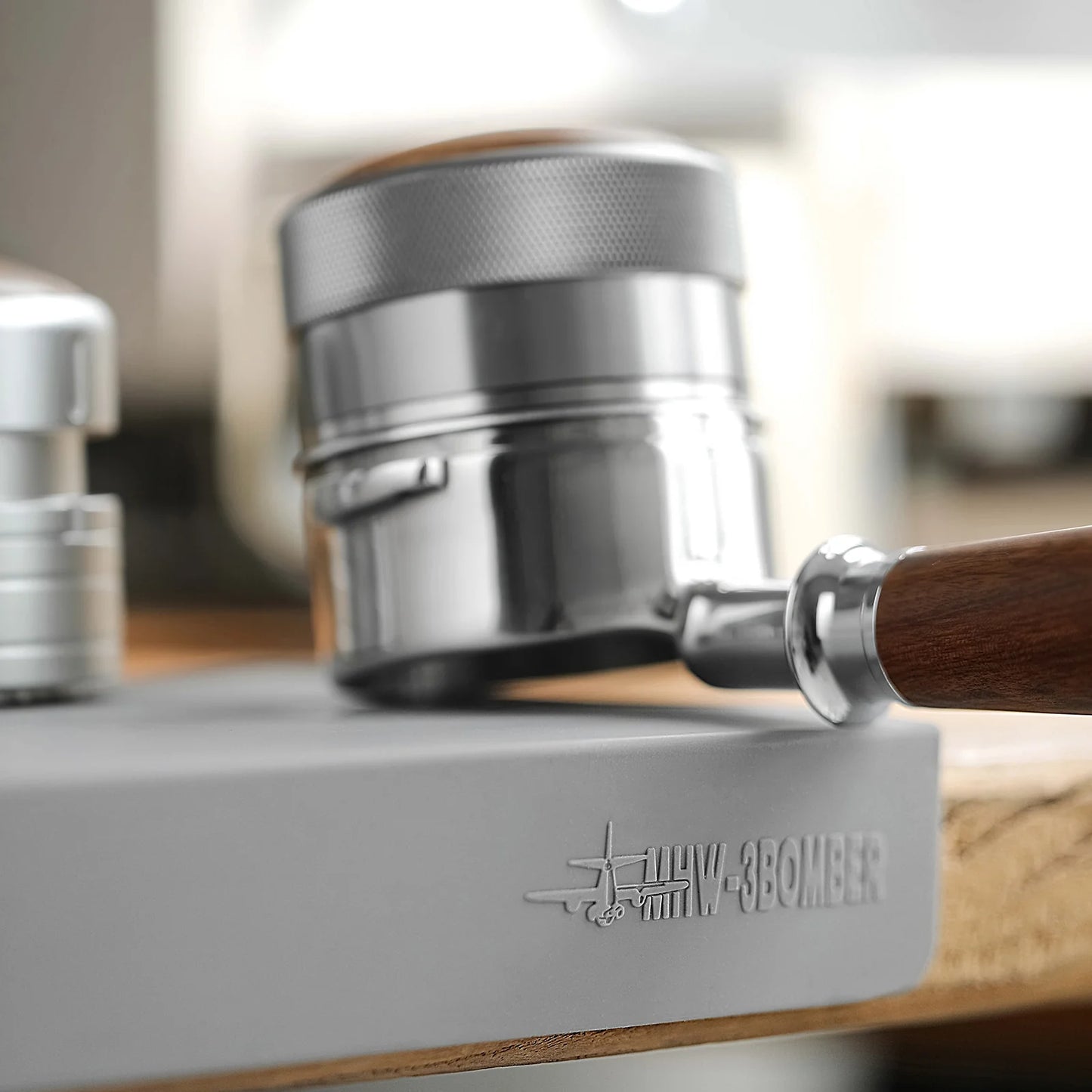 MHW-3BOMBER tamper mat with portafilter. Silicone pad for stable tamping, light gray.