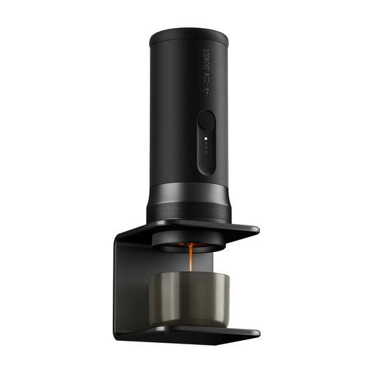 Black coffee brewing device with a lit orange indicator on a white background