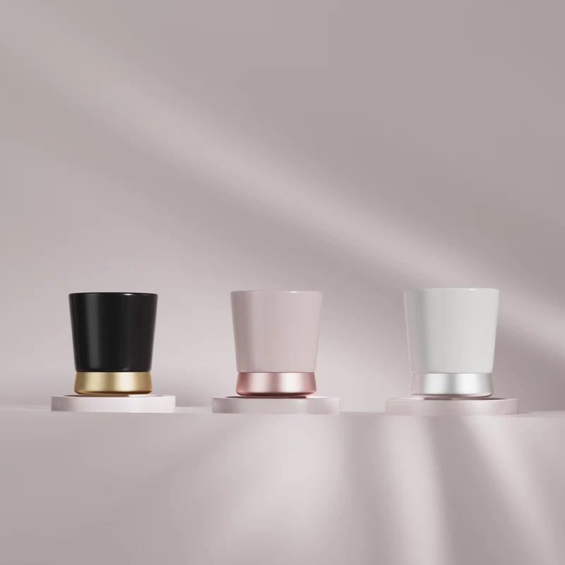 MHW-3BOMBER CERA ceramic cups in black, pink and white with color-blocked metal bases.