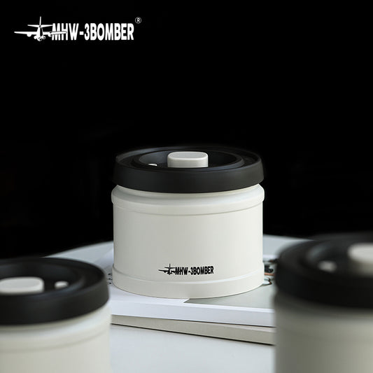 MHW-3BOMBER white coffee vacuum canister with black lid. Vacuum-sealed for freshness.