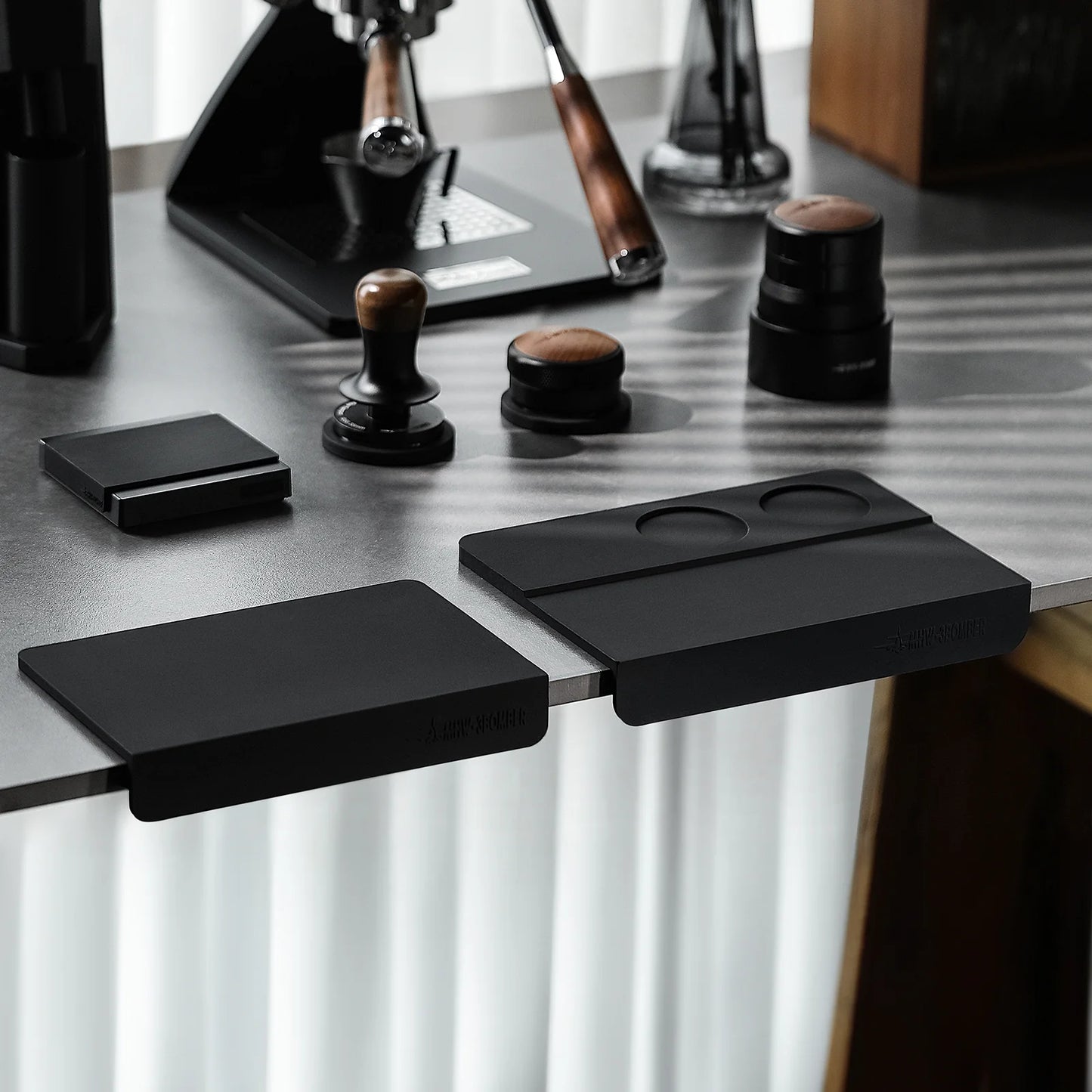 MHW-3BOMBER black silicone coffee tamper mat with two holes, for stable portafilter tamping on a countertop.
