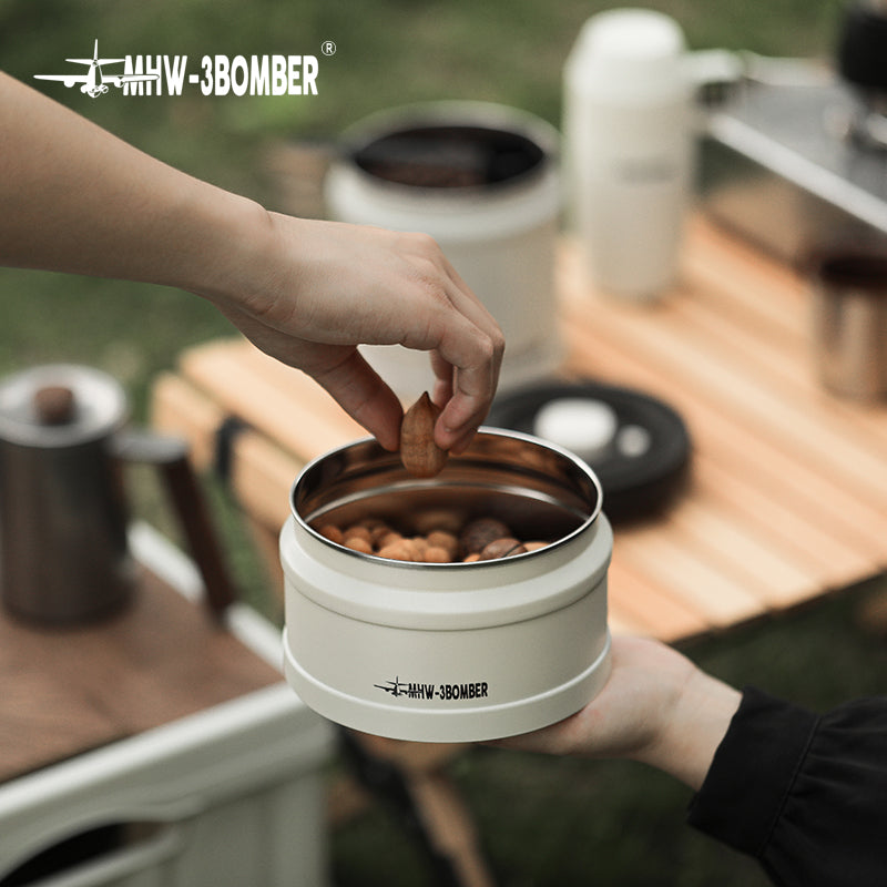 MHW-3BOMBER white vacuum canister with snacks. Stainless steel interior. Sealing design for freshness.