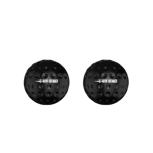 Two MHW-3BOMBER espresso chilling balls in black, with dimpled surfaces