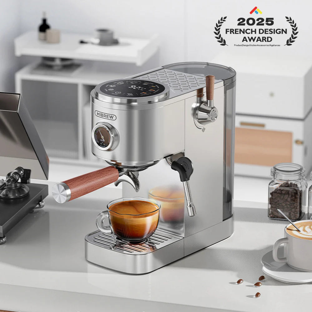 HiBREW H13 espresso machine. Silver with wood accents. French Design Award 2025. On a counter with a cup of espresso.