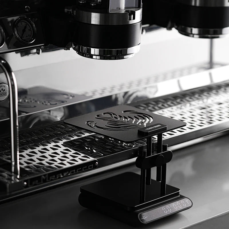 MHW-3BOMBER black coffee scale stand with adjustable height on a La Marzocco espresso machine.