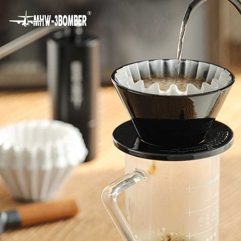 MHW-3BOMBER black Meteor Coffee Dripper being used to brew coffee. Ceramic pour-over coffee maker.