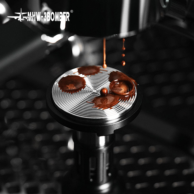 MHW-3BOMBER 58mm Espresso Tamper. Silver, with spiral design. Coffee brewing, close up.