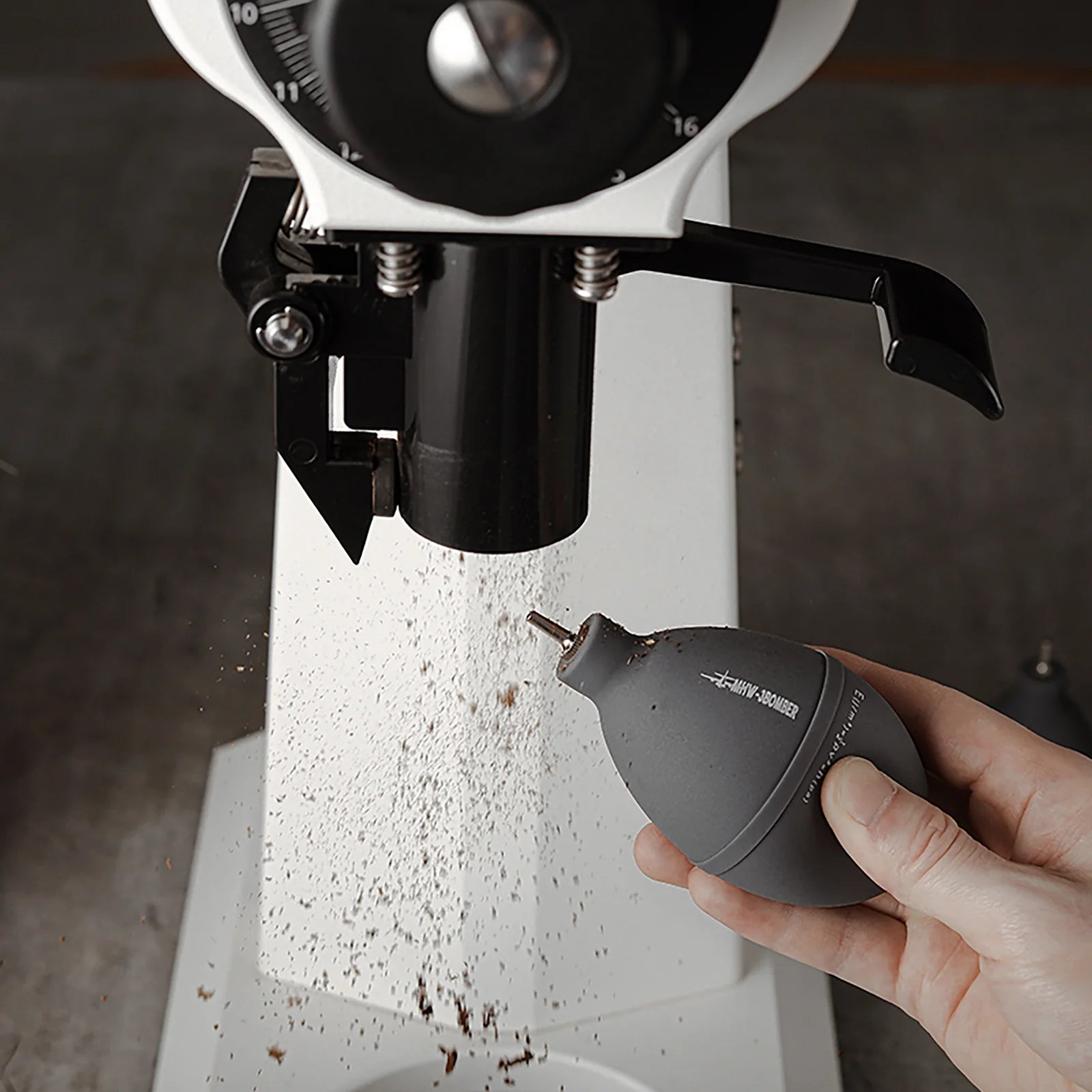 MHW-3BOMBER gray air blower cleaning a grinder. Features tail air intake, air filter, & stainless steel nozzle.
