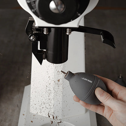 MHW-3BOMBER gray air blower cleaning a grinder. Features tail air intake, air filter, & stainless steel nozzle.
