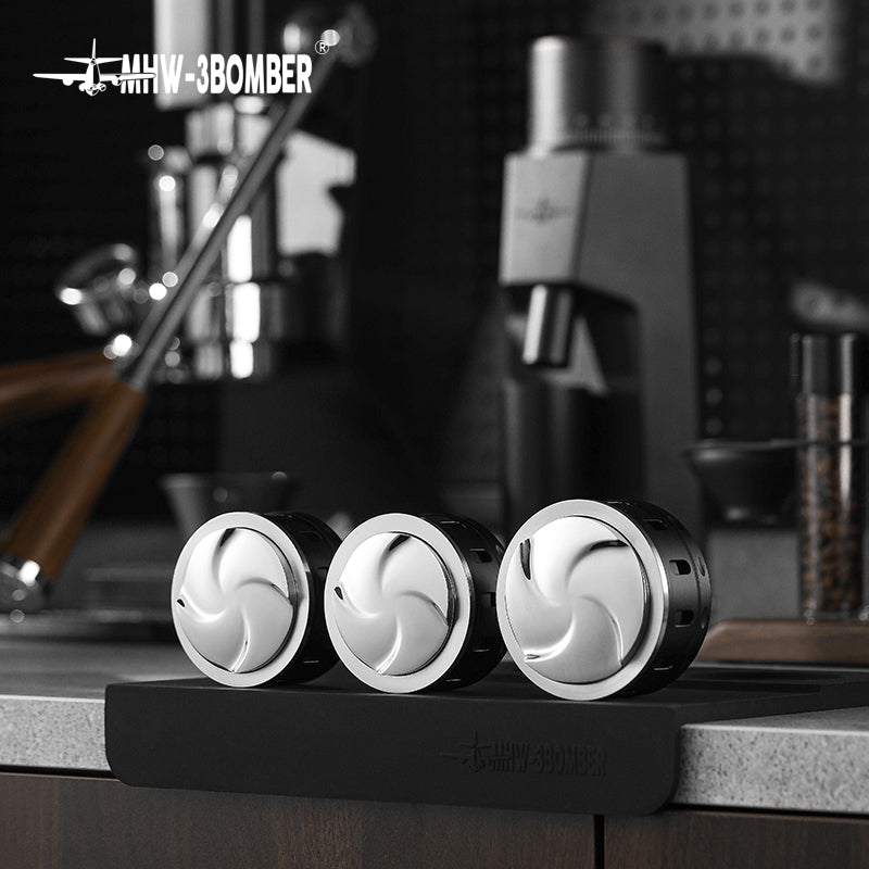 MHW-3BOMBER Falcon Gravity Coffee Distributor in black & silver, on a counter. Espresso extraction tool.