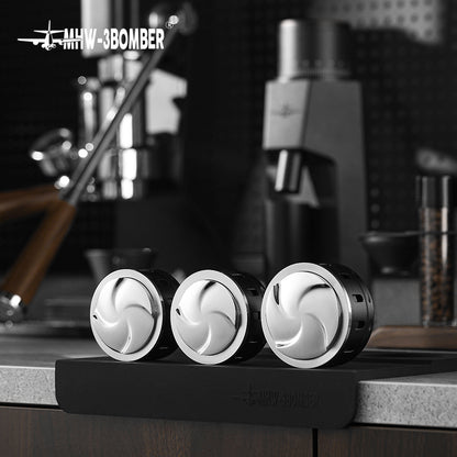 MHW-3BOMBER Falcon Gravity Coffee Distributor in black & silver, on a counter. Espresso extraction tool.