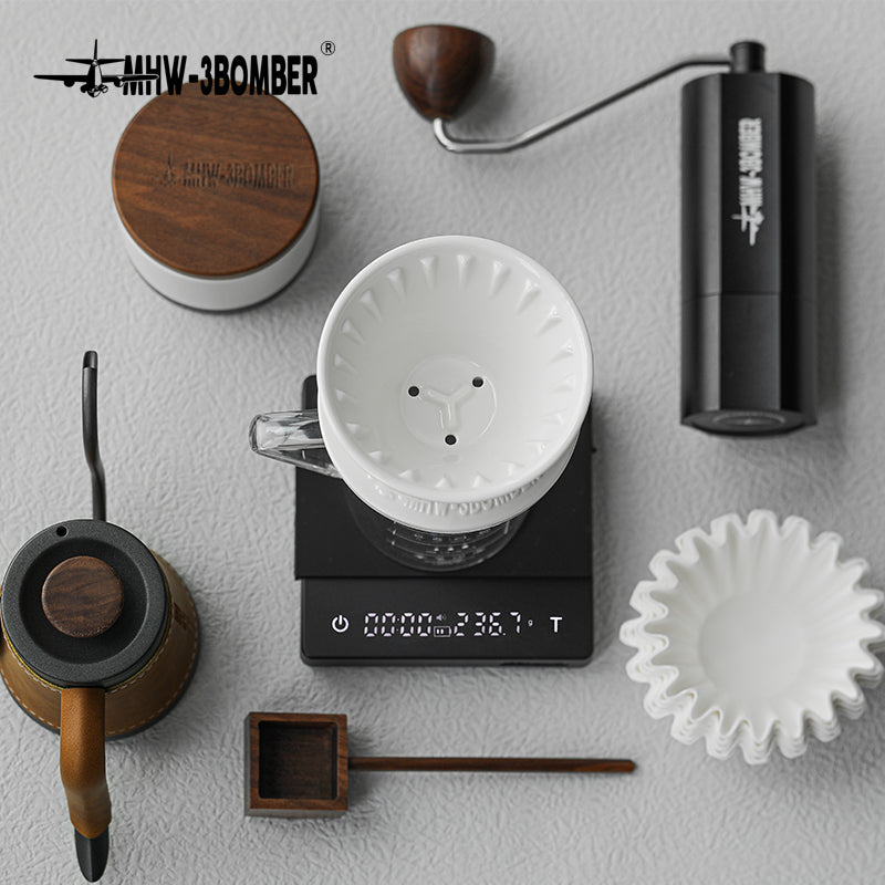 MHW-3BOMBER coffee brewing set. White ceramic dripper, kettle, scale, grinder, filters and scoop.