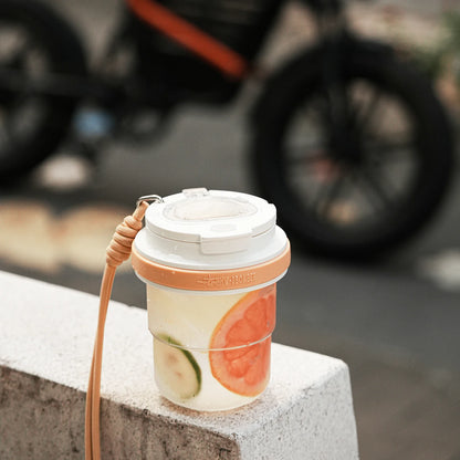 MHW-3BOMBER cold brew cup with fruit infusion. Portable, leak-proof design with strap. Clear body, white lid, orange band.