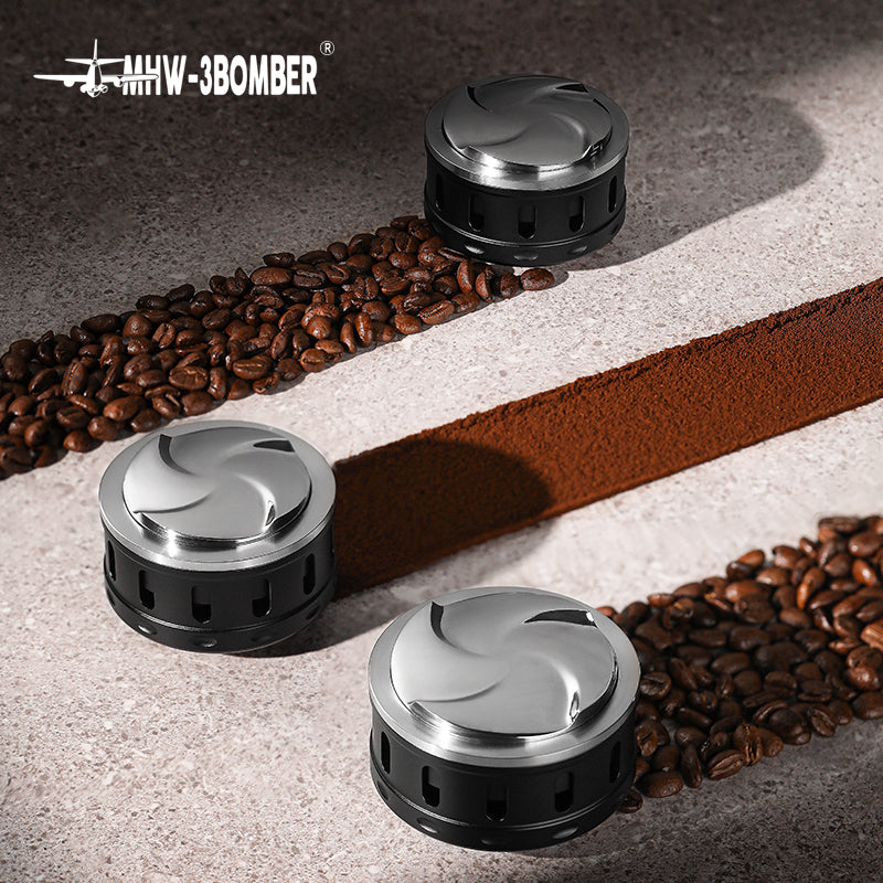 MHW-3BOMBER Falcon Gravity Coffee Distributor. Silver top, black base, on counter with coffee beans. 