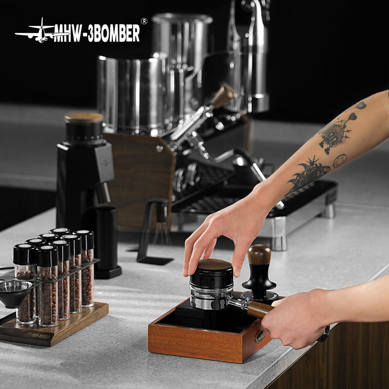 MHW-3BOMBER Falcon Gravity Coffee Distributor being used. Wooden base, stainless steel portafilter. Improves espresso extraction.
