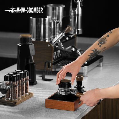 MHW-3BOMBER Falcon Gravity Coffee Distributor being used. Wooden base, stainless steel portafilter. Improves espresso extraction.