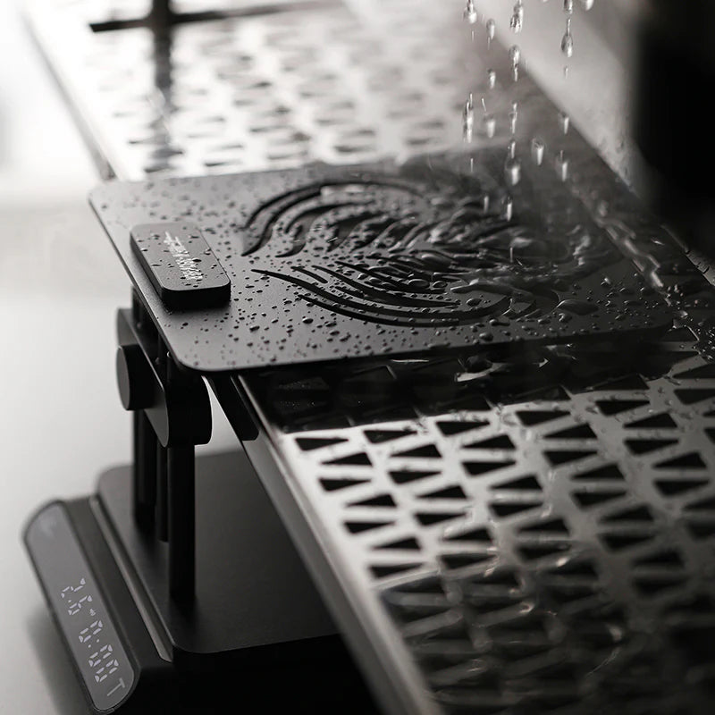 MHW-3BOMBER black coffee scale stand with adjustable height and Phoenix logo. Waterproof barista tool.