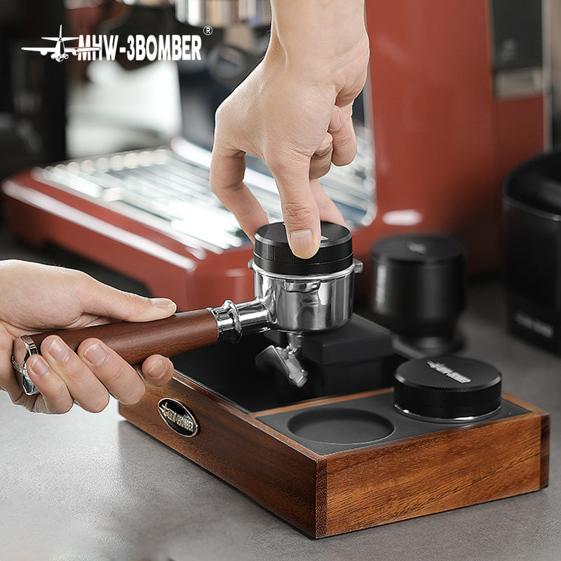 MHW-3BOMBER espresso tamping station with portafilter on wooden holder. 