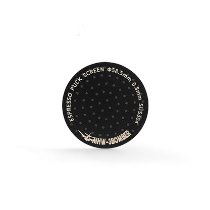 The MHW-3BOMBER Espresso Puck Screen features sleek, black titanium plating with ESPRESSO PUCK SCREEN text along the edge, specifications Φ58.5mm and 0.8mm SUS304, and the bold logo MHW-3BOMBER against a white background.
