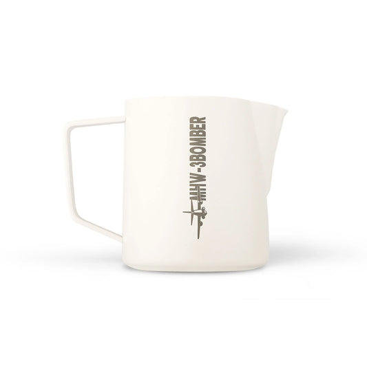 The MHW-3BOMBER Latte Art Pitcher 5.0 White features a simple handle, crocodile spout, and a graphic of an airplane with B-3 BOMBER in dark gray on its plain white surface.