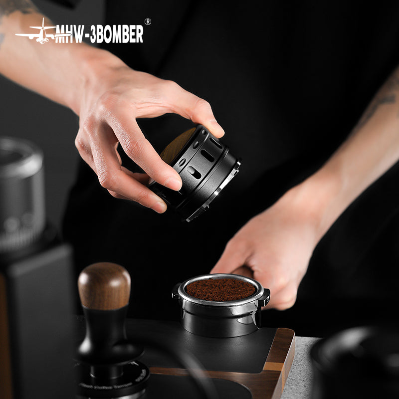 MHW-3BOMBER Falcon coffee distributor being used. Black, gravity adaptive. Helps improve espresso extraction.