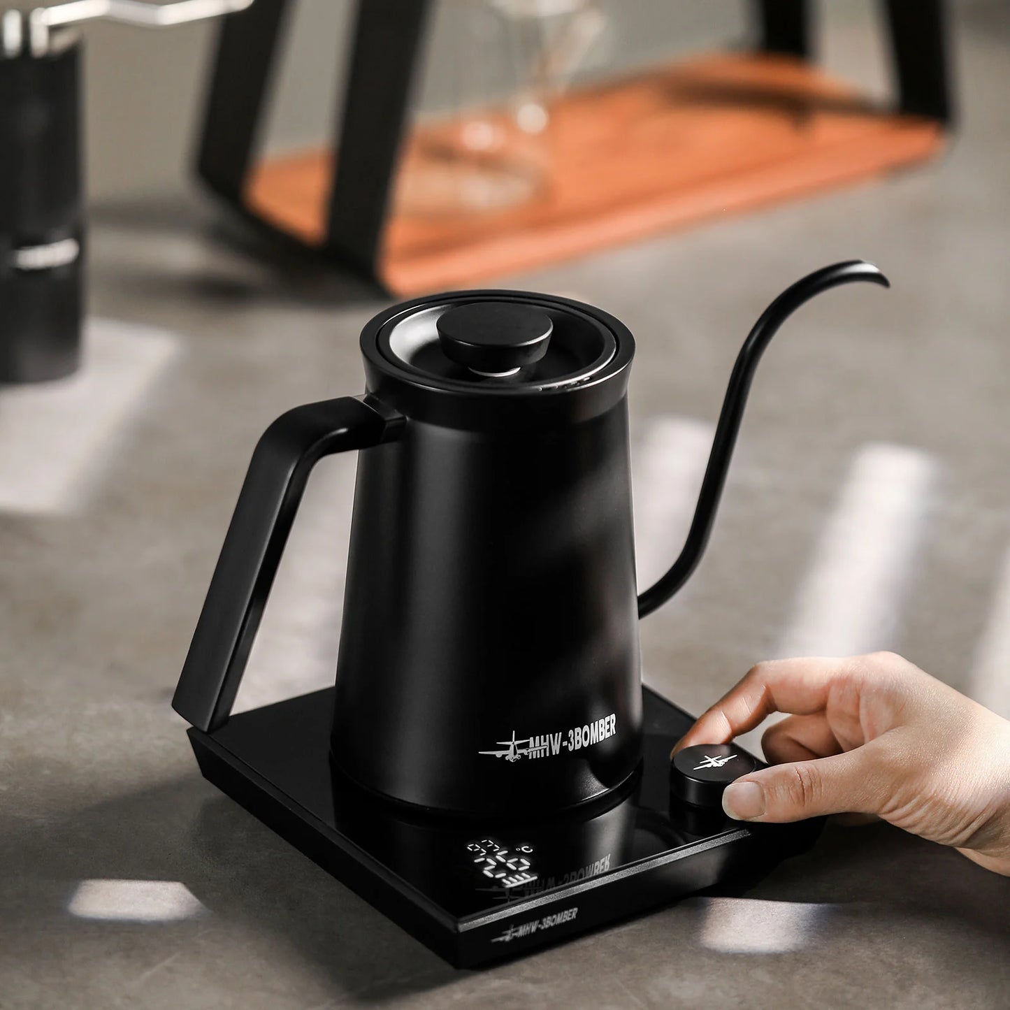 MHW-3BOMBER black gooseneck electric kettle. Precise pour spout, temp control base. Ideal for pour-over coffee. On counter.