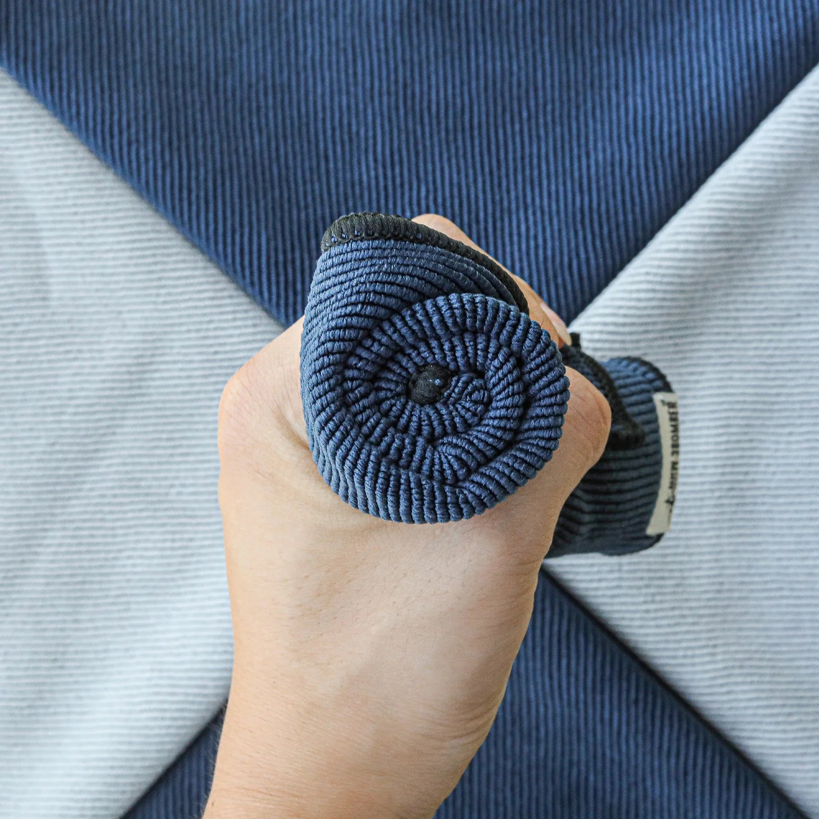 MHW-3BOMBER blue barista towel roll in hand. Textured weave. For coffee bar use. 