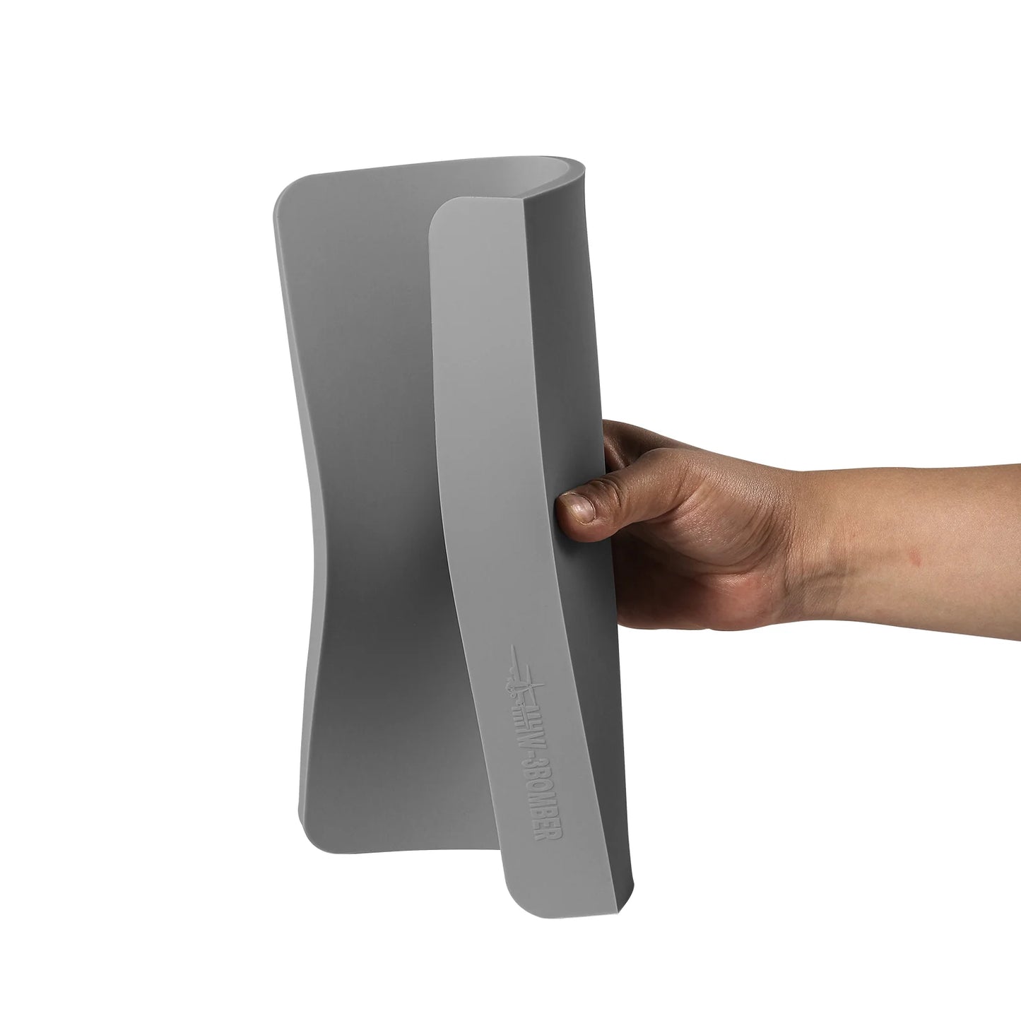 MHW-3BOMBER gray silicone coffee tamper mat with two holes, held by a hand. 