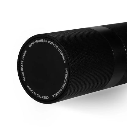 Base view of the MHW-3BOMBER M1 Manual Coffee Grinder in black, featuring stylish engraved text and a textured grip, combining aesthetics and functionality for coffee enthusiasts.