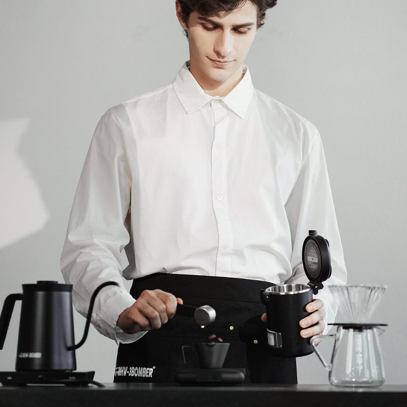 MHW-3BOMBER Gambo Coffee Canister in use. Black canister with scoop & coffee. Freshness preserving bean storage.