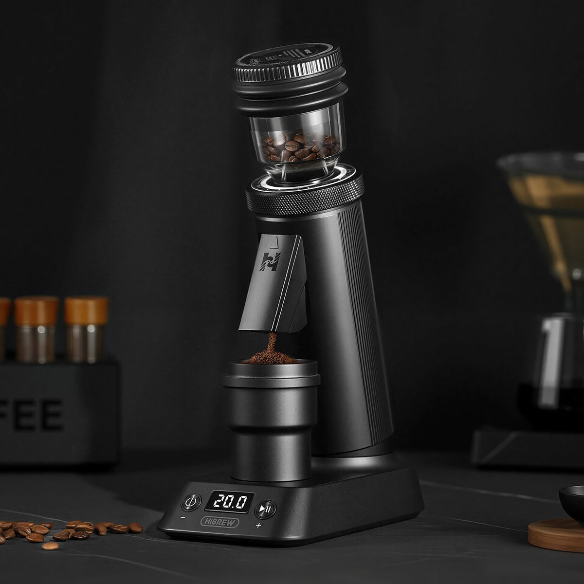 HiBREW G5 Plus grinding coffee into its magnetic dosing cup on a dark kitchen counter, with the base timer reading 20.0 seconds.