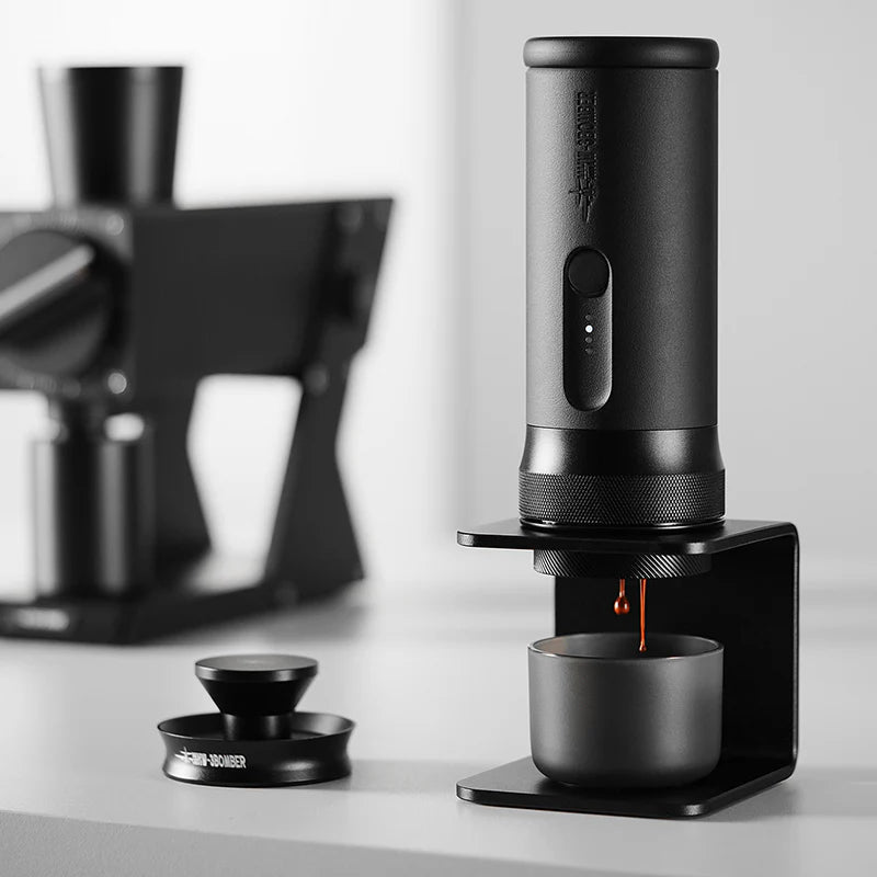 Black coffee brewing device on a white surface with a blurred kitchen background
