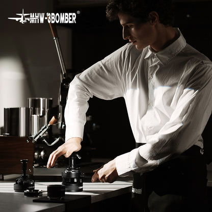 MHW-3BOMBER 58mm espresso tamper in use. Black, force impact design. Professional barista tool.