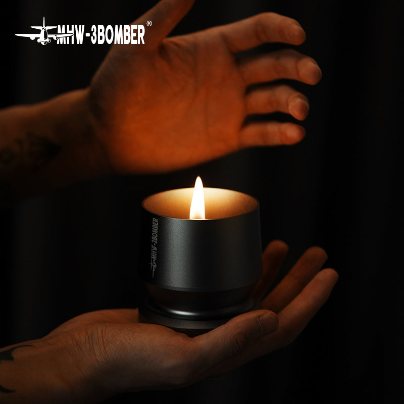 A pair of hands holds an MHW-3BOMBER Espresso Coffee Powder Dosing Funnel against a shadowy background, creating the cozy ambiance that home enthusiasts cherish. The funnels sleek design contrasts beautifully with the surrounding darkness.