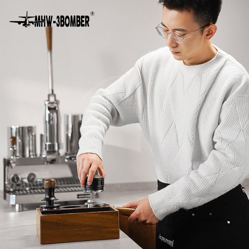 MHW-3BOMBER Falcon coffee distributor. Wooden base with tamper, leveler being used. Enhances espresso. 