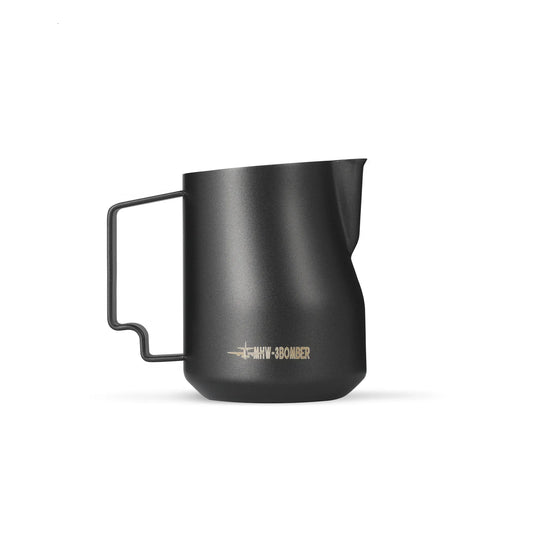 The MHW-3BOMBER Turbo Milk Pitcher Matte Black features a sleek design with a narrow spout and ergonomic handle. MHW-3BOMBER is inscribed in gold near the base. Made from stainless steel, its ideal for professional baristas and latte art enthusiasts.