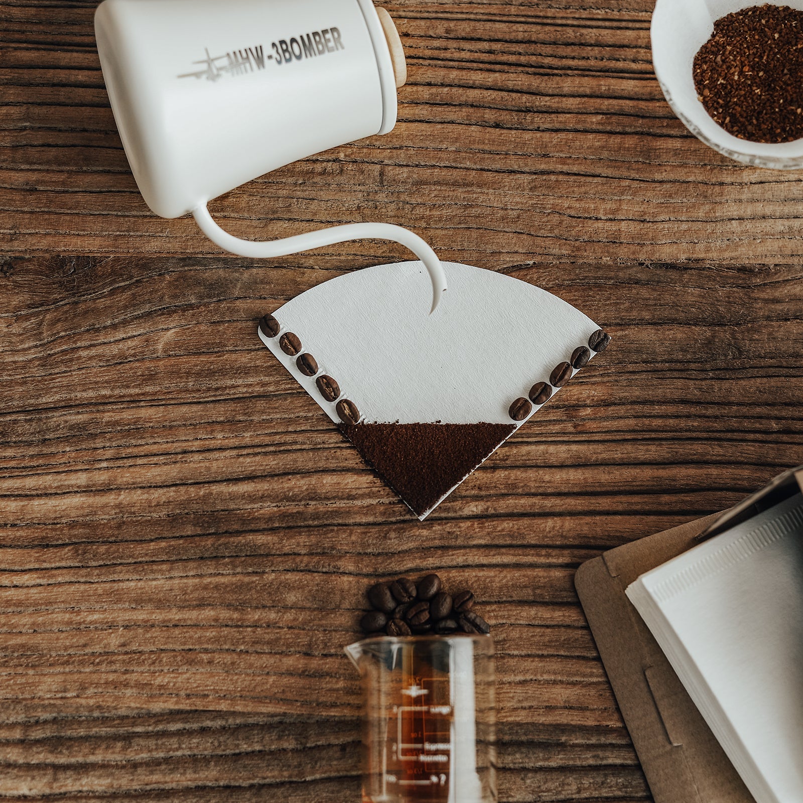 MHW-3BOMBER cone coffee paper filter on wood with coffee beans. Natural wood pulp, single-use. 