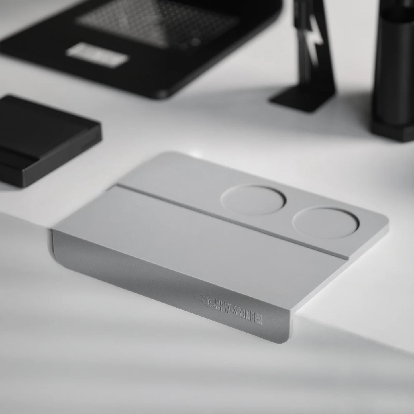 MHW-3BOMBER gray silicone coffee tamper mat with two holes for portafilter stability on counter.