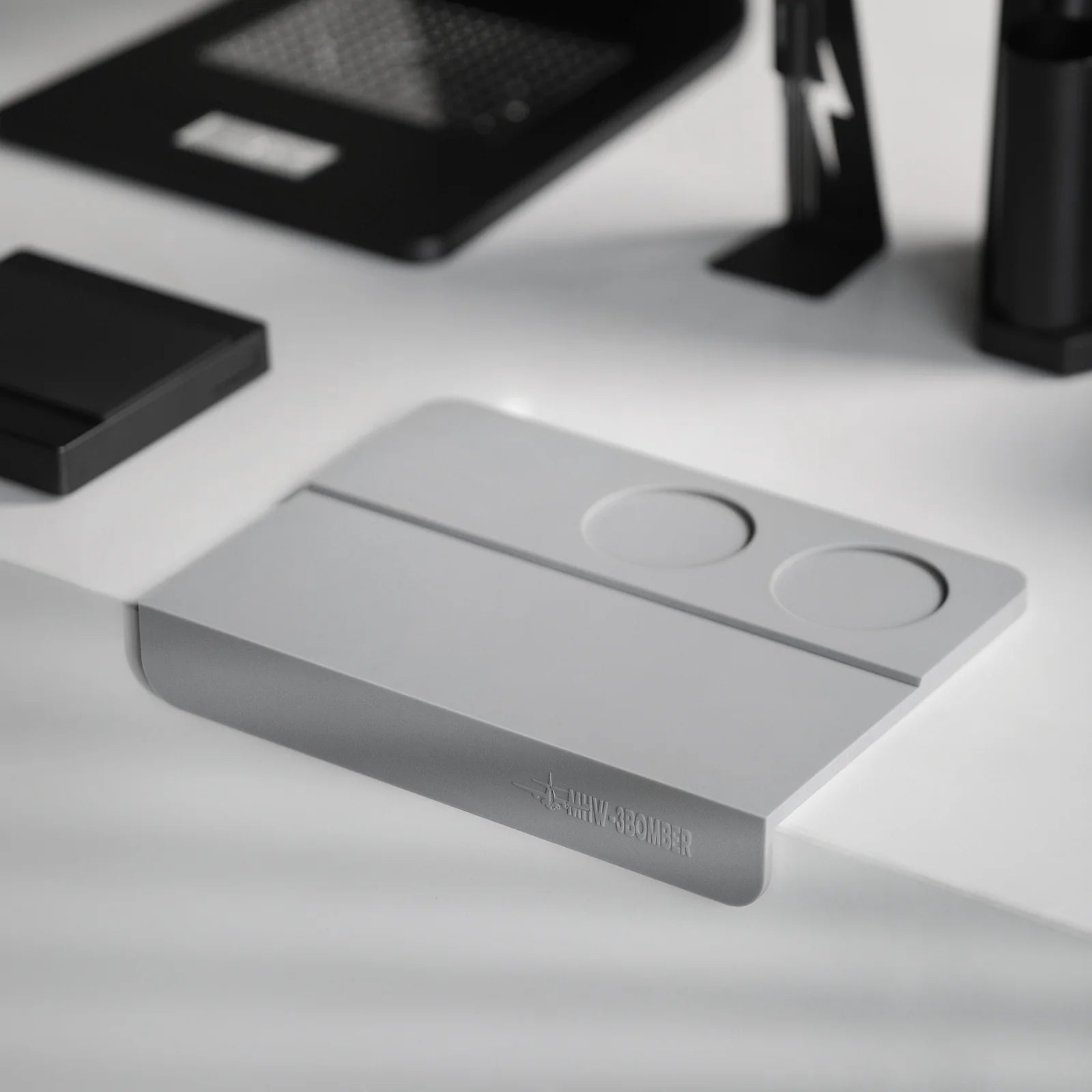 MHW-3BOMBER gray silicone coffee tamper mat with two holes for portafilter stability on counter.