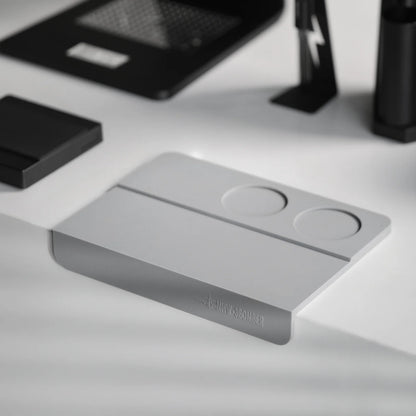 MHW-3BOMBER gray silicone coffee tamper mat with two holes for portafilter stability on counter.