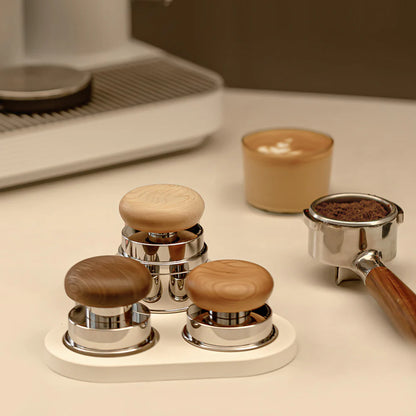 Set of Timemore pucks tampers with wooden knobs on a kitchen counter.