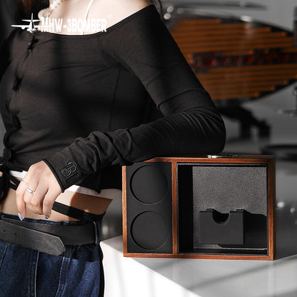 MHW-3BOMBER espresso tamping station. Wood and black design with portafilter holder. Keeps coffee counter tidy.