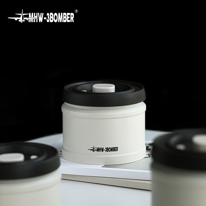 MHW-3BOMBER white coffee vacuum canister with black lid. Vacuum-sealed for freshness. 