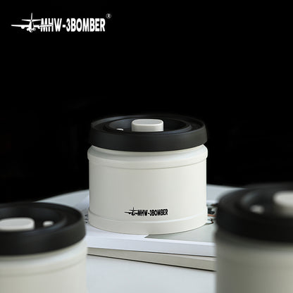MHW-3BOMBER white coffee vacuum canister with black lid. Vacuum-sealed for freshness. 