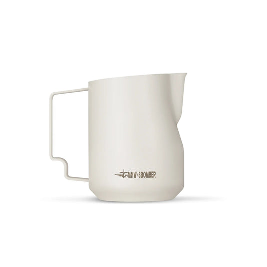 The MHW-3BOMBER Turbo Milk Pitcher White is a minimalist, off-white pitcher with a handle and spout, featuring HMM x 380MIBIER text near the base. Its modern design is set against a plain white background, perfect for latte art.