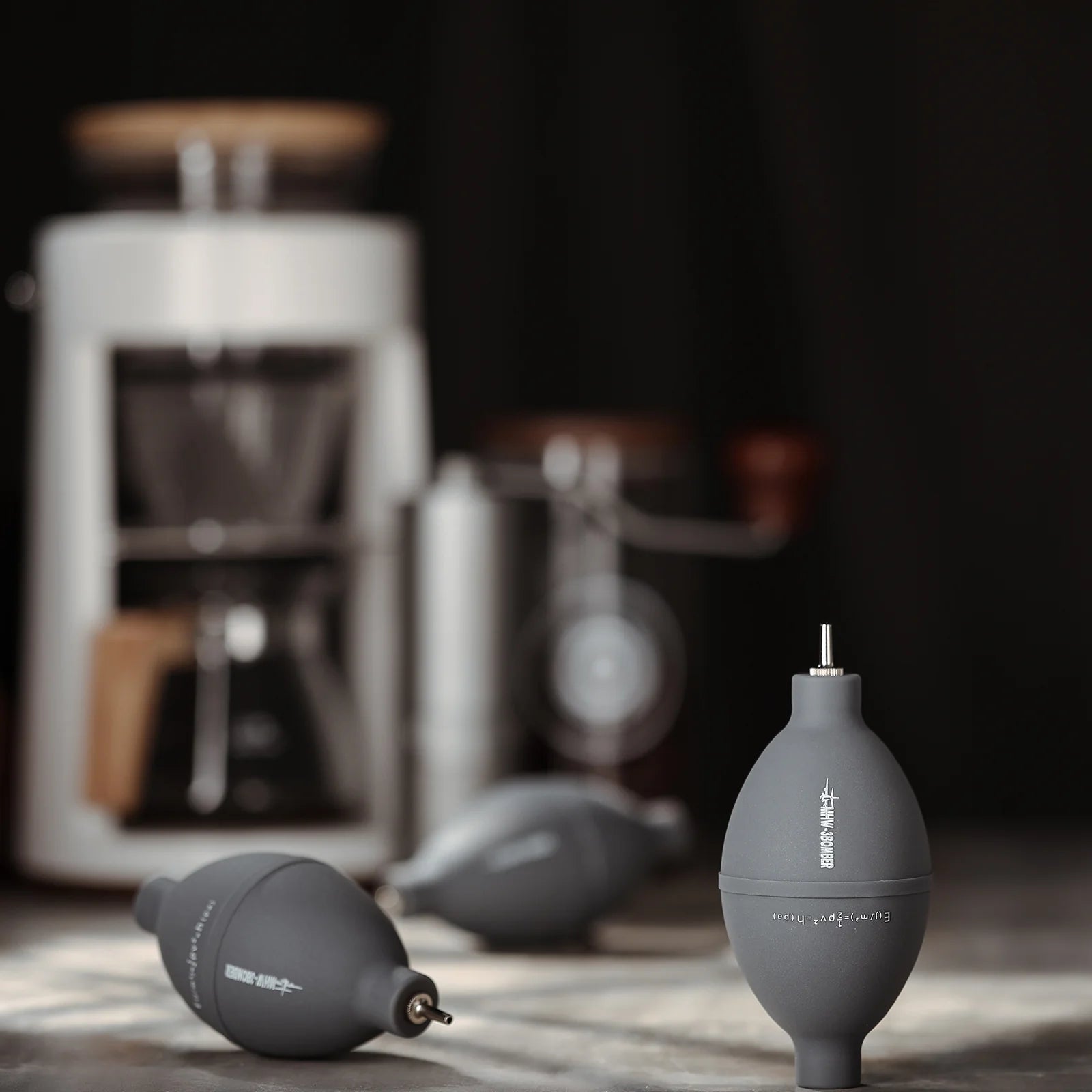 MHW-3BOMBER gray air blower for coffee, silicone & stainless steel, on a counter. 