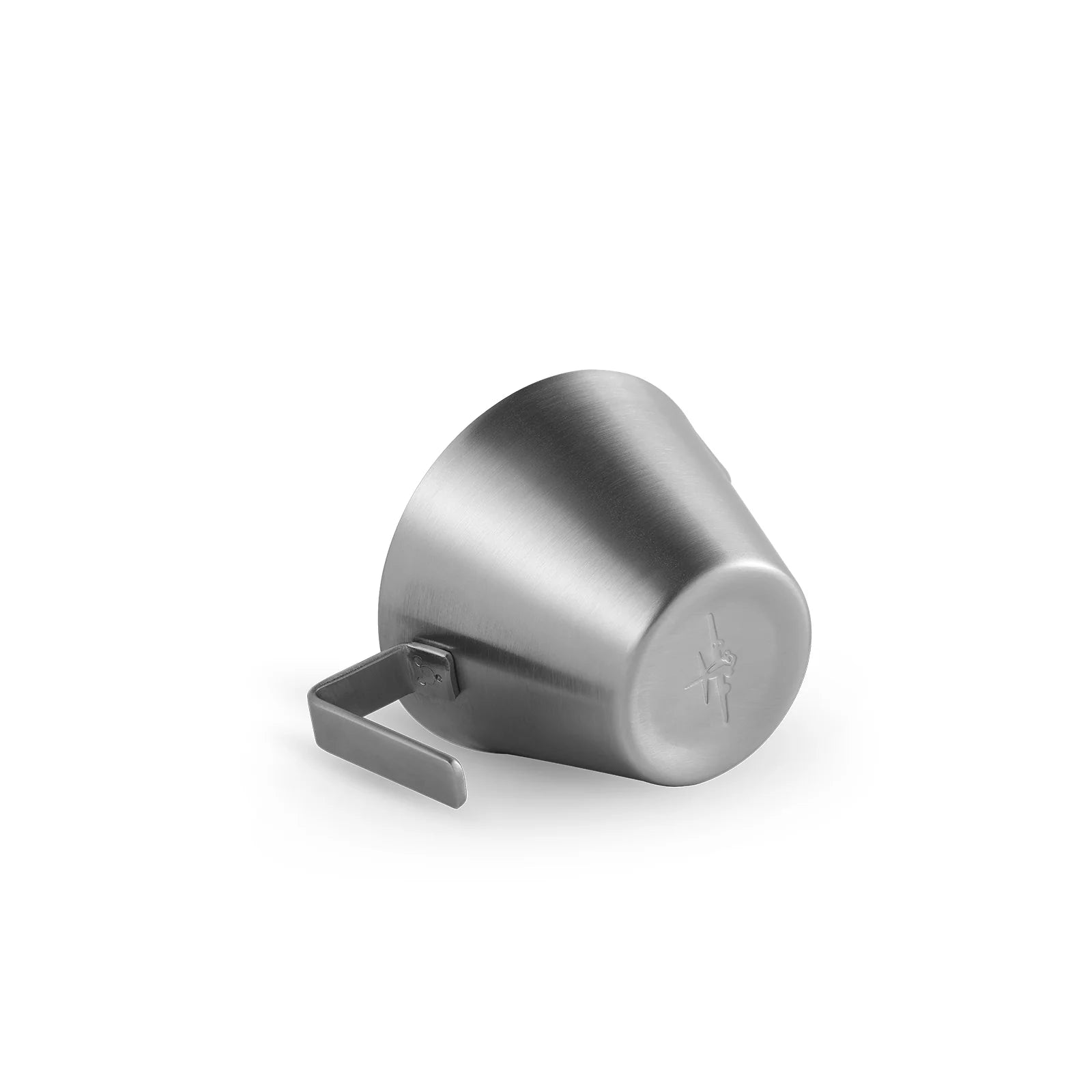 The MHW-3BOMBER Stainless Steel Measuring Cup, tilted on its side with a left-hand handle, is ideal for precise coffee brewing. Its smooth, reflective surface shines against a plain white background.