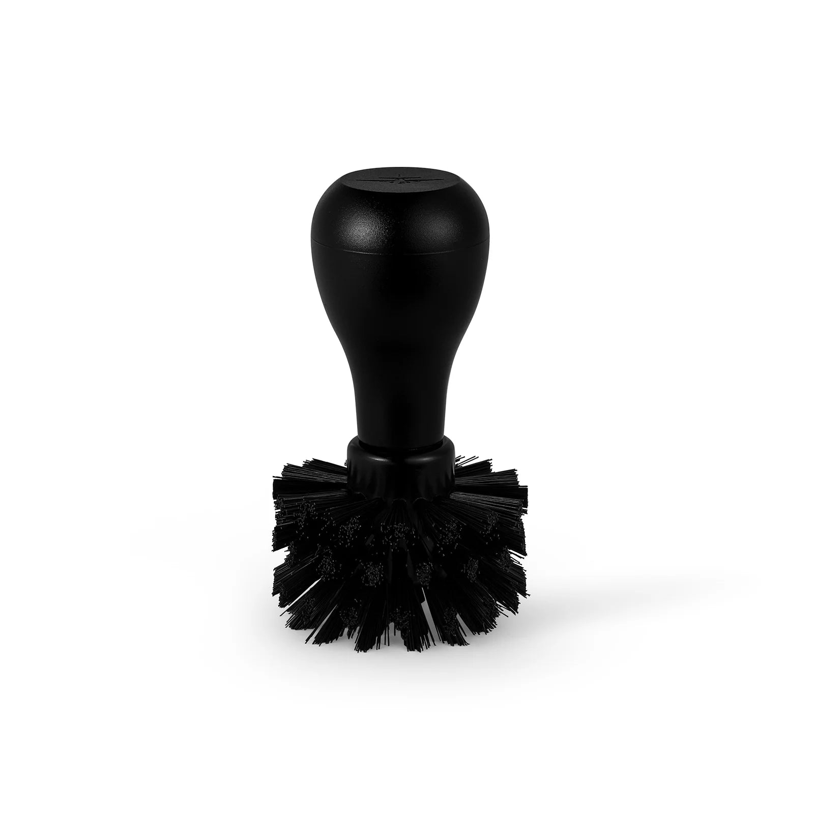 Black portafilter cleaning brush with round handle, part of Daily Cleaning Essentials Kit. 